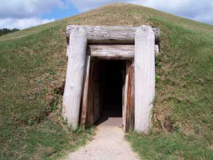 Under a large earthen mound, covered with grass, is an underground passage to an earth lodge where archaeologists believe the natives held ceremonies.  The wooden supports still survive, although the entrance has been propped open with modern logs.