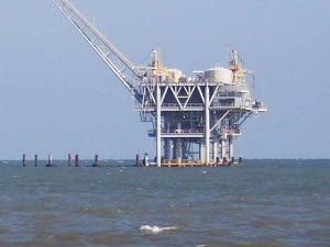 On a three-level grey steel tower sits the oil rig in Mobile Bay