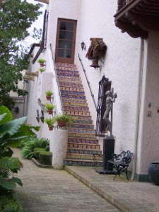 Each step on the outside staircase is tiled with a different mosaic tile.