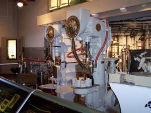 Two large white machines with gleaming brass trim and red and black hoses were used a century ago to mix the Dr. Pepper syrup.  Now a museum display.