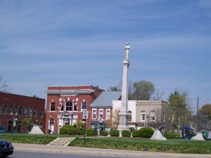 In the center of the square stands a three story pedestal topped by a standing Confederate soldier