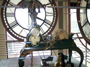 Immediately behind the clock face, the old clock works are on display, still working