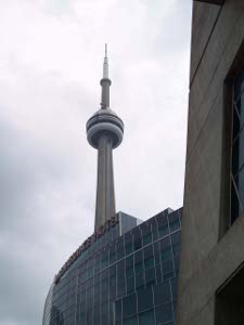 The CN Tower, with its large observation ring, rises above Toronto buildings