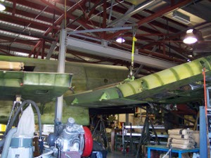 The greenish finished metal on two wing segments of the Haviland bomber under restoration