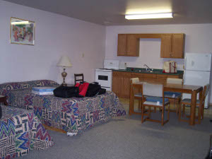 The inside of the motel room, with kitchen and dining table