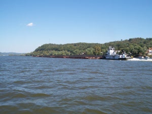 A pushboat controls a string of seven coal barges down the Ohio River