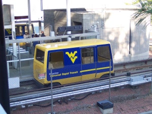 One Blue and Gold Personal Rapid Transit Car waits at each side of the station at the Medical Center.