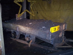 An old mine car, about eight feet long, to hold enough coal for $1 in wages