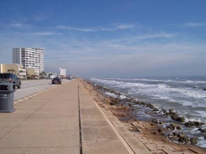 the beach road stretches for miles along the Galveston beach