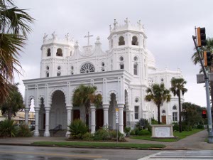 The Sacred Heart Church has low towers, Moorish architecture, with an arcade in front