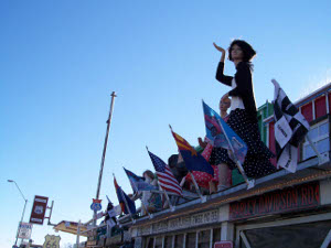 On historic U.S. 66, flags and mannikins decorate the roof of a mercantile establishment in Seligman, Arizona.