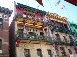 the second stories of the two buildings in Chinatown are brightly painted and decorated