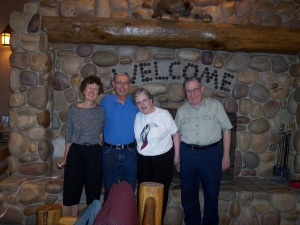Four Friends pose in front of the massive stone fireplace at Ruby's Inn