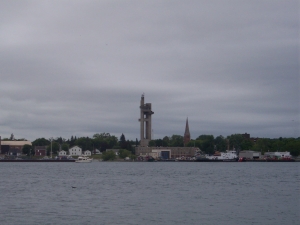 A large tower and a nearby church steeple form the skyline of Sault Ste. Marie, Michigan