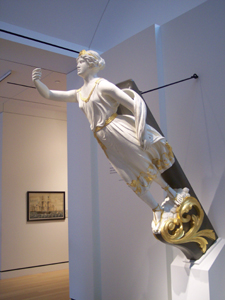 The figurehead from an old sailing vessel depicts a woman in white flowing
robes, trimmed with gold