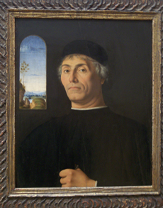 A sensitive portrait of a man in black cassock and cap, with an open
window in the background showing sky and trees and distant mountains