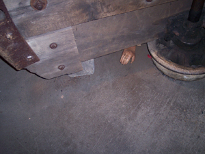 Display showing a mining cart with the hand of a crushed person