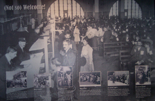 The photograph of masses of immigrants waiting to be processed at 
Ellis Island is labeled (Not so) Welcome!