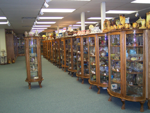 Many display cabinets filled with glass at the Baker Family Museum.