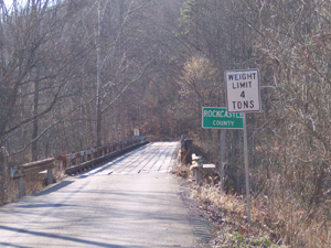 One lane wooden bridge with signs, Weight Limit 4 Tons, and Rockcastle County.