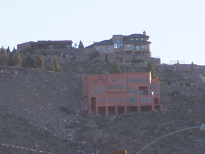 Large homes in coral and sand-colored stucco cling to the rocky hillsides north of El Paso.