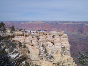 Tourists stand on Mather Point overlooking the Grand Canyon
