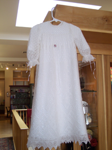 Knitted in an open pattern with an underskirt, the blessing dress is about four feet long