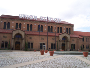 Brick building in moorish style with large cobblestoned plaza.  Sign on roof reads UNION STATION in
large white block letters