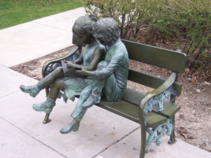 An artist has created a bronze park bench in Ogden, Utah, with statues of two children seated
on the bench and sharing a book to read.