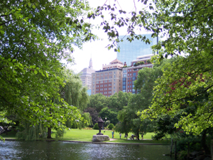 View of Boston Garden showing pond with city skyline and John Hancock building in background