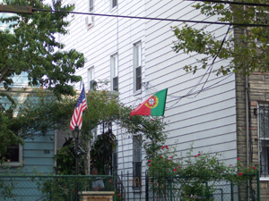 A resident displays American and Portuguese flags