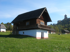 A Building in the Skanzen outdoor museum with the Stara L'Ubovnia castle in the background.