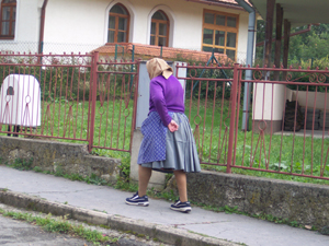 A woman walking in a small village