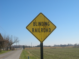 The road sign says, Blinding Railroad