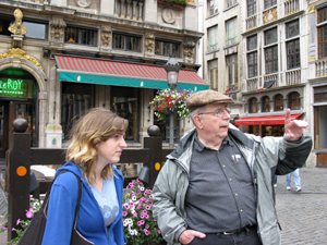 Bob instructs Emily in the Grand Place