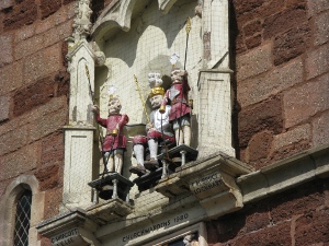 On the side of the building, the clock features a king and two lancers, each about 2 feet tall