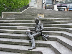 Sitting three steps up, his left leg extended downward, Chamberlain appears almost alive in this unusual bronze sculpture