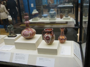 The vases have an intricate pattern of red, orange, and silver