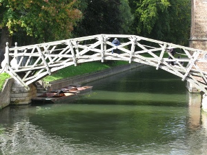 Made of grey-painted wood, the frame bridge makes a lovely arch over the river Cam