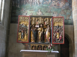 The triptych features doors left and right which could be closed to conceal the art depicting an event in the life of a saint