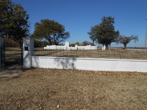 A brick wall, painted white, surrounds the large foundation of the 101 Ranch home.