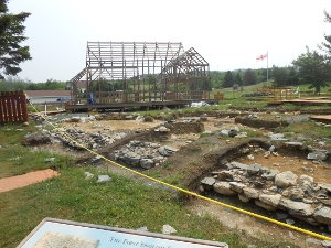 The dig has opened up the ground over the foundations of John Guy's original colony.  A wooden frame structure has been erected to explain the size of the colony buildings.