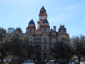With many towers, including the tallest clock tower, the courthouse built of red brick and tan stone reaches to the sky.