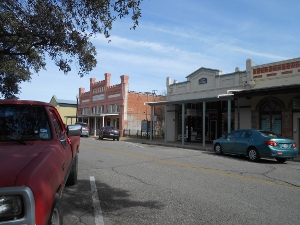 Old time facades built of wood and brick with porches to keep off the sun in downtown Bastrop