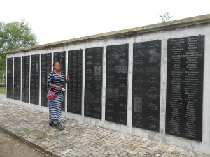 ten tall plaques inscribed with names on one side of the memorial