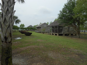 large iron kettles for processing sugar cane and slave quarters moved to the property