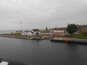 On the corner of land adjacent to the harbor entrance, the Coast Guard Station in Ludington has three lovely white buildings with maroon roofs overlooking the waterfront.