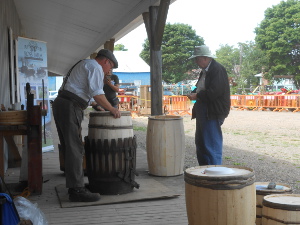 The barrel is in a form to keep it shaped while the cooper starts a ring of softened birch