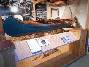 The blue boat has varnished wood covered by a fabric skin.