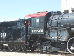The co-author can be seen waving from the large black steam locomotive